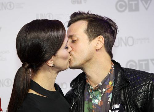 Chantal Kreviazuk and Raine Maida, awarded the 2014 Allan Waters Humanitarian Award, at the Juno Awards share a kiss on the red carpet. (Joe Bryksa/ Winnipeg Free Press)