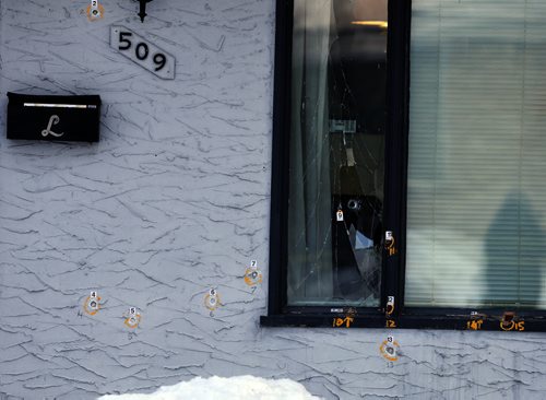 WPS mark bullet holes in house -Shooting .For the second morning in a row a house at 509 Seven Oaks Ave had bullets shot at it penetrating the front wall and picture window. April 1 2014 / KEN GIGLIOTTI / WINNIPEG FREE PRESS