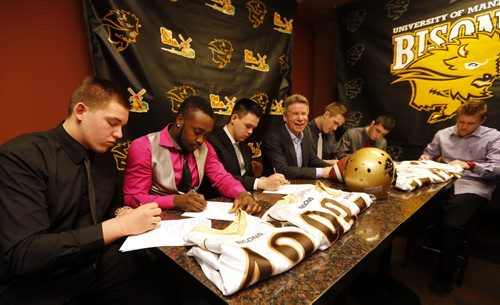 UofM Bison's Football coach Brian Dobie is happy to sign six local recruits for this upcoming season .LtoR (not their real sweater numbers) O-L 42 Braedan Cheang , DB 93 Dane Douglas , QB 7 Drenin Busch , DB 17 Eric Plett  , R 74 Anthony Dyck , R 71 Riley  Harrison . story by melissa martin   April 1 2014 / KEN GIGLIOTTI / WINNIPEG FREE PRESS