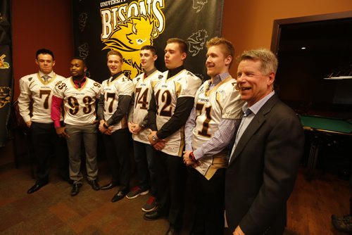 UofM Bison's Football coach Brian Dobie is happy to sign six local recruits for this upcoming season .LtoR (not their real sweater numbers), QB 7 Drenin Busch ,DB 93 Dane Douglas, DB 17 Eric Plett  , R 74 Anthony Dyck, O-L 42 Braedan Cheang ,R 71 Riley  Harrison,UofM Bison's Football coach Brian Dobie at signing newser. story by melissa marin April 1 2014 / KEN GIGLIOTTI / WINNIPEG FREE PRESS