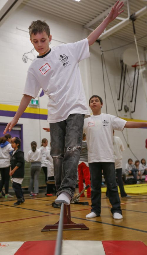 Gabee Borland, 12, left, learns to walk the tight rope and is cheered on my his friend, Brenden Suppes, 12, at the 17th annual Circus and Magic Partnership (C.A.M.P) at Gordon Bell High School in Winnipeg on Tuesday, April 1, 2014. C.A.M.P is an artistic intervention project for at-risk kids, spearheaded by the Winnipeg International Children's Festival . (Photo by Crystal Schick/Winnipeg Free Press)