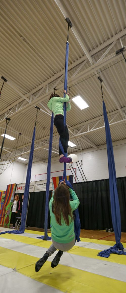 Children learn how to climb and maneuver on the silks at the 17th annual Circus and Magic Partnership (C.A.M.P) at Gordon Bell High School in Winnipeg on Tuesday, April 1, 2014. C.A.M.P is an artistic intervention project for at-risk kids, spearheaded by the Winnipeg International Children's Festival . (Photo by Crystal Schick/Winnipeg Free Press)
