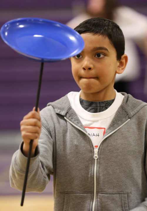 Isaiah Cabral, 10, learns to spin a disk on a stick at the 17th annual Circus and Magic Partnership (C.A.M.P) at Gordon Bell High School in Winnipeg on Tuesday, April 1, 2014. C.A.M.P is an artistic intervention project for at-risk kids, spearheaded by the Winnipeg International Children's Festival . (Photo by Crystal Schick/Winnipeg Free Press)