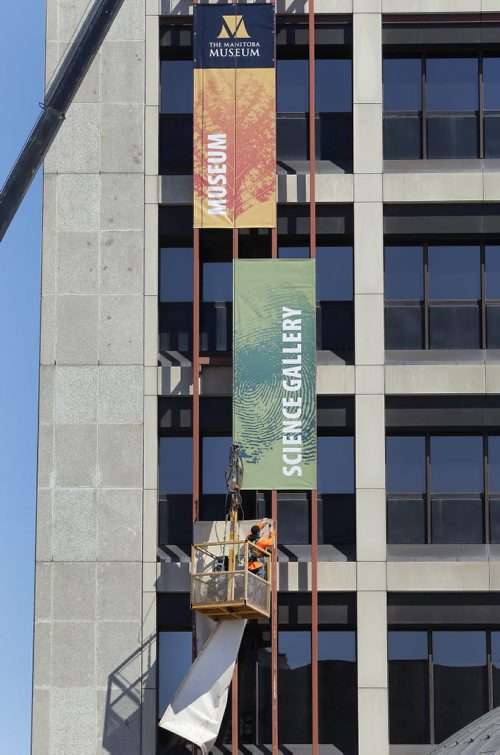 Stdup , workers hang new banners. The Manitoba Museum is getting new signage , it is open with  spring break activities and exhibits raging from The Mummy Pesed ,  a display on saving Lake Winnipeg  , and an exhibit of  Real Pirates . April 2 2014 / KEN GIGLIOTTI / WINNIPEG FREE PRESS