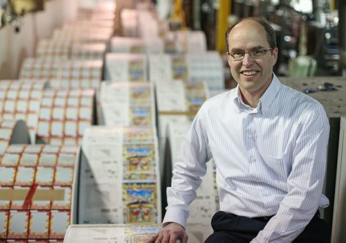 John Pollard, co-CEO of Pollard Banknote Limited, is on a roll, literally, as he sits atop instant-win lottery tickets in the printing plant in Winnipeg on Wednesday, April 2, 2014. The company is rolling out new initiatives which will allow them to expand their already world-class business. (Photo by Crystal Schick/Winnipeg Free Press)
