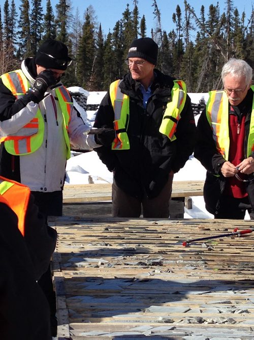 Mega CEO Glen Kuntz (middle) with mining analyst inspecting core samples.  April 2014 Martin Cash / Winnipeg Free Press