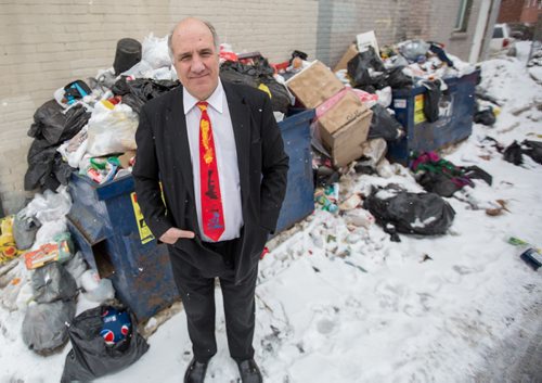 Tom Ethans, executive director of Take Pride Winnipeg, stands in front of his enemy, garbage and litter, in Winnipeg on Thursday, April 3, 2014. The organization's Team Up To Clean Up campaign is to get people thinking about cleaning up garbage and litter around the city. (Photo by Crystal Schick/Winnipeg Free Press)