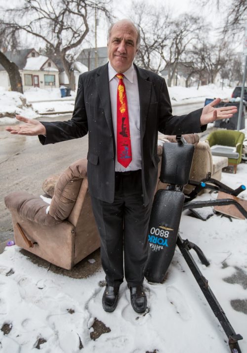 Tom Ethans, executive director of Take Pride Winnipeg, stands in front of his enemy, curb side trash, in Winnipeg on Thursday, April 3, 2014. The organization's Team Up To Clean Up campaign is to get people thinking about cleaning up garbage and litter around the city. (Photo by Crystal Schick/Winnipeg Free Press)