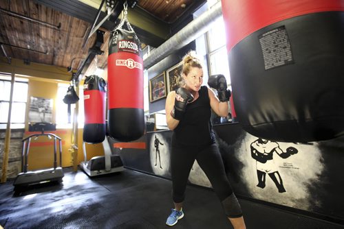 Tracy Tjaden trains on the bag at the Pan Am Boxing Club.  Story on the boxing clubs "Fight Club" a high intensity 12-week workout designed to push you to your limits.  For Sunday Extra. March 27, 2014 Ruth Bonneville / Winnipeg Free Press