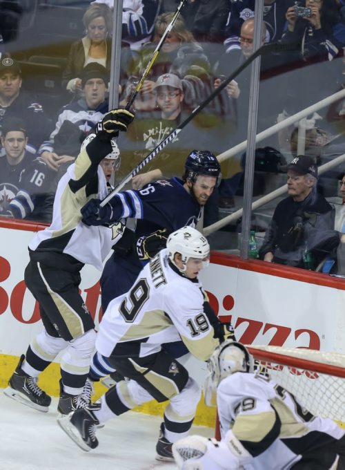 Winnipeg Jet captain #16 Andrew Ladd, battles the Pittsburgh Penguins #3, Olli Maatta, and #19 Beau Bennett, in first period action at the MTS Cnetre in Winnipeg on Thursday, April 3, 2014. The first period ended 1 to 0 for the Penguins. (Photo by Crystal Schick/Winnipeg Free Press)
