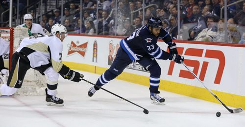 Winnipeg Jet, #33 Dustin Byfuglien, is chased down in second period action by Pittsburgh Penguin, #7 Paul Martin, at the MTS Cnetre in Winnipeg on Thursday, April 3, 2014. The first period ended 1 to 0 for the Penguins. (Photo by Crystal Schick/Winnipeg Free Press)