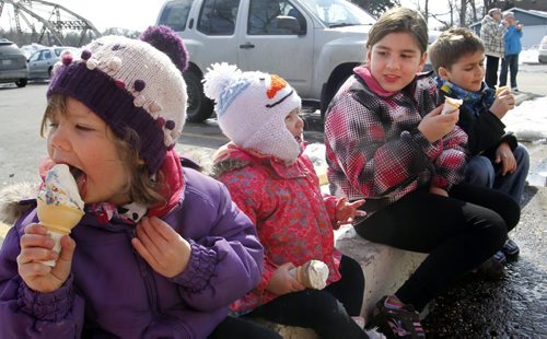 From left Danika,3, and sister Deah, 18mos. beside Austyn,8, and her brother Thayne,6, sit on a curb at the BDI Friday afternoon and enjoy their first ice cream of the year at the popular ice cream location.   For weather story.  Wayne Glowacki / Winnipeg Free Press April 4   2014