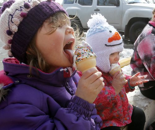 From left Danika,3, and sister Deah, 18mos. sit on a curb at the BDI Friday afternoon and enjoy their first ice cream of the year at the popular ice cream location.   For weather story.  Wayne Glowacki / Winnipeg Free Press April 4   2014