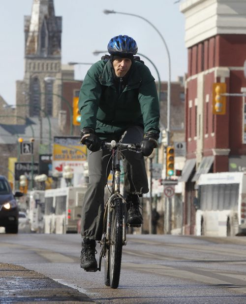 A cyclist rides Osborne St. Friday afternoon, he maybe interested to know there will be a public open house on Saturday between 11am and 4pm at the Manitoba Theatre for Young People at 2 Forks Market Road for citizens to participate in an open house to review draft recommendations that will shape the future of walking and cycling in Winnipeg. Over the last several months, the City has been developing strategies that will help guide transportation choices in Winnipeg. see release.  Wayne Glowacki / Winnipeg Free Press April 4   2014