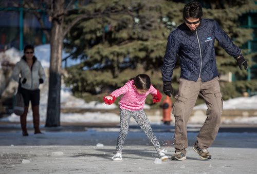 The skating rink at the Forks is closed for the season, but that didn't stop Chylsy Marable from challenging her dad Jay to a game of foot hockey on the melted rink Friday afternoon. 140404 - Friday, {month name} 04, 2014 - (Melissa Tait / Winnipeg Free Press)