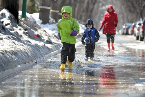 Six year old Anika Durksen runes through a large puddle on Evanson Street with her little brother Felix - 3yrs   on their way to the store with mom Saturday .  Standup Photo April 05, 2014 Ruth Bonneville / Winnipeg Free Press