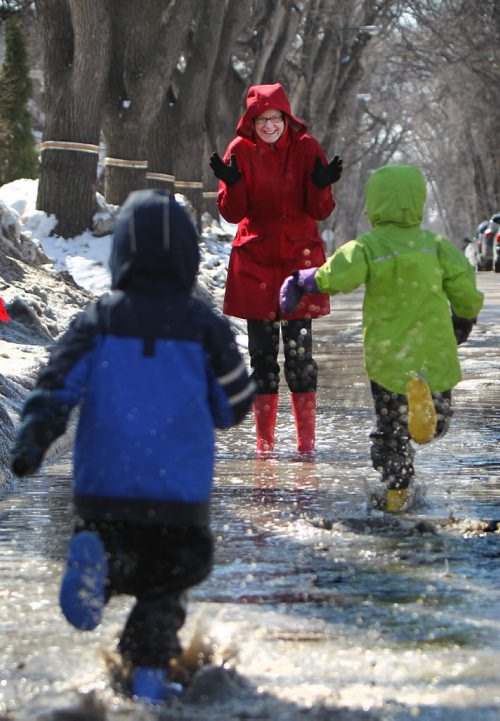 Six year old Anika Durksen and her little brother Felix - 3yrs race  to  their mom while playing in a puddle on their way to the store  Saturday in Wolsely.  Standup Photo April 05, 2014 Ruth Bonneville / Winnipeg Free Press
