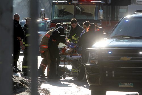 A women is  placed on a stretcher after being hit by a car while she was crossing Broadway Ave at Donald Street at about 5pm Saturday afternoon. April 05  2014 Ruth Bonneville / Winnipeg Free Press