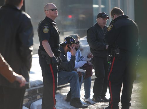 The driver of the vehicle that hit a women  crossing Broadway Ave at Donald Street Saturday afternoon is surrounded by Police Officers while he makes calls on his phone at the scene. April 05  2014 Ruth Bonneville / Winnipeg Free Press
Shane Recksiedler (on phone) was convicted of dangerous driving causing death.
