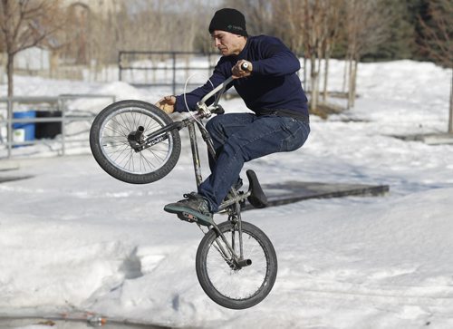 Morghan Okaluk, 25, rides his BMX at the skate park at The Forks after he and some friends used shovels to clear some room to ride, Saturday, April 5, 2014. There is no major indoor facility to accomodate BMX bikes during the winter, and many riders are anxious to get a start on the season. (TREVOR HAGAN/WINNIPEG FREE PRESS)