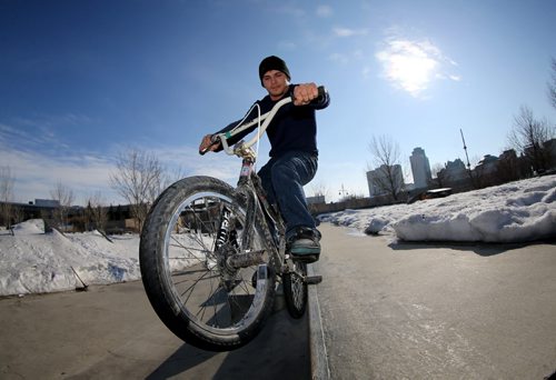Morghan Okaluk, 25, rides his BMX at the skate park at The Forks after he and some friends used shovels to clear some room to ride, Saturday, April 5, 2014. There is no major indoor facility to accomodate BMX bikes during the winter, and many riders are anxious to get a start on the season. (TREVOR HAGAN/WINNIPEG FREE PRESS)