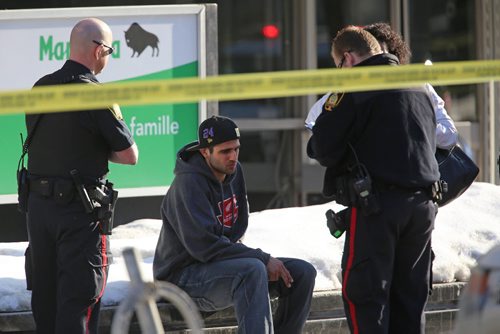 Police interview a man near the corner Broadway and Donald after a pedestrian was struck by a vehicle, Saturday, April 5, 2014. (TREVOR HAGAN/WINNIPEG FREE PRESS) ----WE THINK THIS IS THE DRIVER