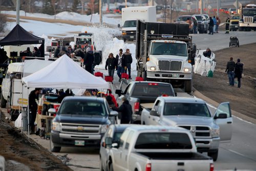 The "One Christmas Eve" movie production has closed the William R Clement Parkway, Saturday, April 5, 2014. A truck dumped snow into the middle of the road, and a Bobcat was being used to spread it around. (TREVOR HAGAN/WINNIPEG FREE PRESS)