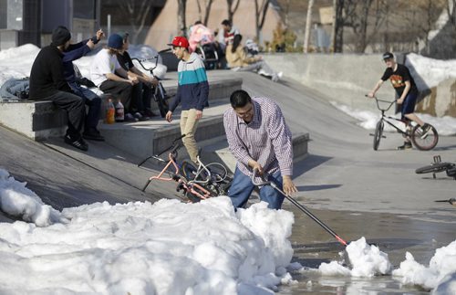 Snow is cleared at the skate park at The Forks to allow BMX riders some room to ride, Saturday, April 5, 2014. There is no major indoor facility to accomodate BMX bikes during the winter, and many riders are anxious to get a start on the season. (TREVOR HAGAN/WINNIPEG FREE PRESS)