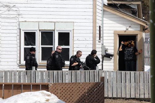 A suspect comes out of a house that the Winnipeg Police have surrounded on Selkirk Ave.  Winnipeg Police have closed the 700 block of Selkirk off and have surrounded a house.  140406 April 06, 2014 Mike Deal / Winnipeg Free Press