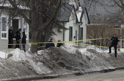 Winnipeg Police have swarmed an area  around Manitoba Ave and McKenzie St , the scene of an apparent shooting , police are patrolling the area  checking lane ways in the area . April 7 2014 / KEN GIGLIOTTI / WINNIPEG FREE PRESS