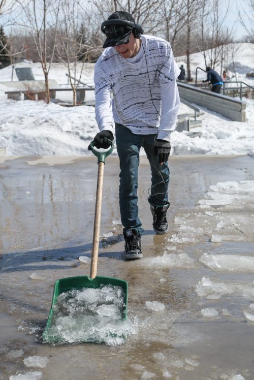 Jaime Deluca, a BMXer, is one of dozens who volunteered to shovel water, ice and snow at the Plaza skatepark at the Forks in order to get the park in dry usable condition as soon as possible in Winnipeg on Monday, April 7, 2014. The volunteers, users of the skatepark, were invited via Facebook event and they hope to have most of the park uncovered by the end of the day. (Photo by Crystal Schick/Winnipeg Free Press/Winnipeg Free Press)