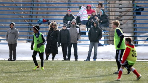 Winnipeg parents brave snow covered sidelines as young soccer players jockey for position on teams for the upcoming season during tryouts at the WInnipeg Soccer Complex Monday evening. See story. April 7, 2014 - (Phil Hossack / Winnipeg Free Press)