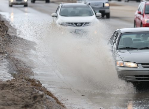 The recent warm weather creates a wet commute home for drivers in Winnipeg on Monday, April 7, 2014. (Photo by Crystal Schick/Winnipeg Free Press/Winnipeg Free Press)