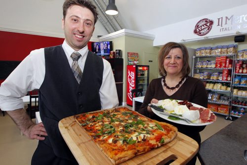Restaurant review - Cafferia 360. (L)Massimo Buono and (R)Donna Casale pose for a photo in their newly expanded restaurant on Corydon. Massimo holds the fungi pizza and Donna holds a special Italian Burrato, Mozzarella di Bufala and Red peppers cruschi from Basilicapa, Southern Italy. BORIS MINKEVICH / WINNIPEG FREE PRESS April 8, 2014