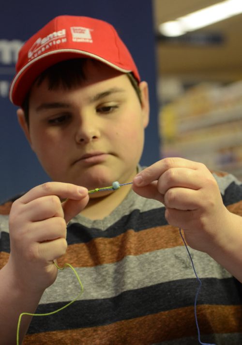 Spencer Lambert, 13, beads a necklace at the Easter Seals SMD Foundation media event at Safeway Osborne Village.  The motto of the event was to find ability in disability through inclusive camp model.  EMILY CUMMING / WINNIPEG FREE PRESS APRIL 8, 2014