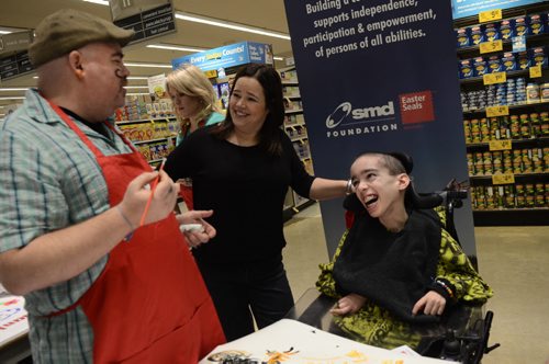 Mitchell Potter, 19, laughs at Big Daddy Tazz as he paints a moustache on himself during the Easter Seals SMD Foundation media event at Safeway Osborne Village.  The motto of the event was to find ability in disability through inclusive camp model.  EMILY CUMMING / WINNIPEG FREE PRESS APRIL 8, 2014