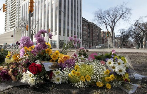 The flower memorial on Broadway and Donald St. Wednesday morning for Amy Gilbert who was fatally injured at the intersection when she was struck by a car on Saturday. see Web/Gord Sinclair story. Wayne Glowacki / Winnipeg Free Press April 9   2014