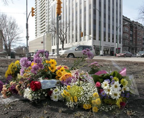 The flower memorial on Broadway and Donald St. Wednesday morning for Amy Gilbert who was fatally injured at the intersection when she was struck by a car on Saturday. see Web/Gord Sinclair story. Wayne Glowacki / Winnipeg Free Press April 9   2014