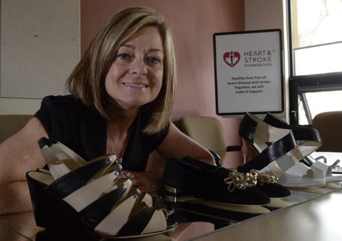 Trish Taylor, Community Partnership & Events Manager for the Heart & Stroke Foundation, poses with a pair of shoes in advance of the shoe auction. EMILY CUMMING / WINNIPEG FREE PRESS APRIL 9, 2014