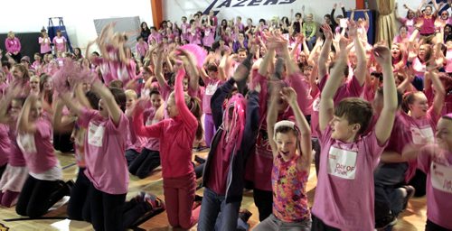 Students at Lincoln Middle School were wearing their pink T shirts and doing the wave while shouting "Stand for Respect" at the Canadian Red Cross Day of Pink celebration held at their school Wednesday. The event included words from James Allum, Education and Advanced Learning Minister and Obby Khan, former Winnipeg Blue Bomber player who spoke of his experiences of bullying and ended with anti-bulling videos produced by the students were shown. The students and staff were among the over 19,000 people across Manitoba standing for respect wearing pink T-shirts. In Manitoba more than 365 schools and businesses are hosting events that include film festivals, speakers' series, rallies, and parades to inspire others to recognize and respond to bulling.     see release. Wayne Glowacki / Winnipeg Free Press April 9   2014