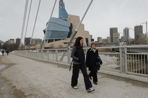 Dr. Adrienne Leslie-Toogood (L) takes a walk across the Esplanade Riel bridge along with her mother Jodi.  Leslie-Toogood is the director of sports psychology at the Canadian Sport Centre Manitoba and often walks to maintain good health.  EMILY CUMMING / WINNIPEG FREE PRESS APRIL 9, 2014