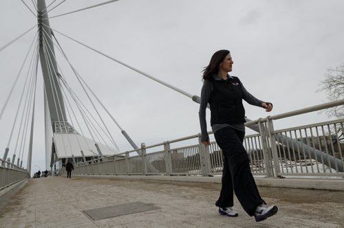Dr. Adrienne Leslie-Toogood takes a walk across the Esplanade Riel bridge.  Leslie-Toogood is the director of sports psychology at the Canadian Sport Centre Manitoba and often walks to maintain good health.  EMILY CUMMING / WINNIPEG FREE PRESS APRIL 9, 2014