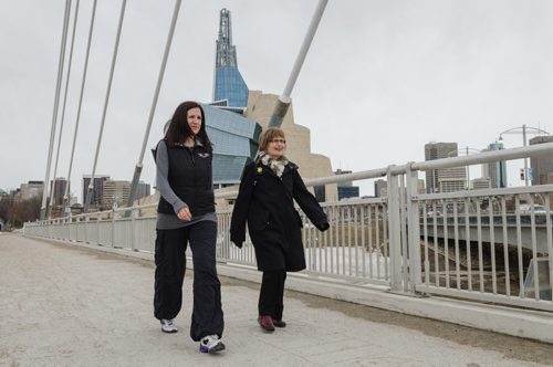 Dr. Adrienne Leslie-Toogood (L) takes a walk across the Esplanade Riel bridge along with her mother  Jody Miles.  Leslie-Toogood is the director of sports psychology at the Canadian Sport Centre Manitoba and often walks to maintain good health.  EMILY CUMMING / WINNIPEG FREE PRESS APRIL 9, 2014