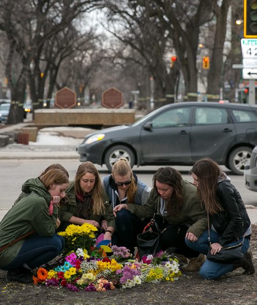 Kayla Prokopchuk (centre) is surrounded by childhood friends of Amy Gilbert at a memorial of flowers on Broadway at Donald Street, where Gilbert was struck and killed Saturday afternoon. The group of friends have known each other since Grade 7. From left to right, Megan Dudeck, Michelle Eacha, Kayla Prokopchuk, Merdith Stoesz, April Saurette, Angela Harris.    140409 - Wednesday, {month name} 09, 2014 - (Melissa Tait / Winnipeg Free Press)
