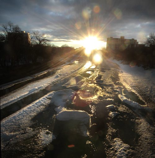 The sun rises over a thawing Assiniboine River Thursday morning.  Wayne Glowacki / Winnipeg Free Press April 10   2014
