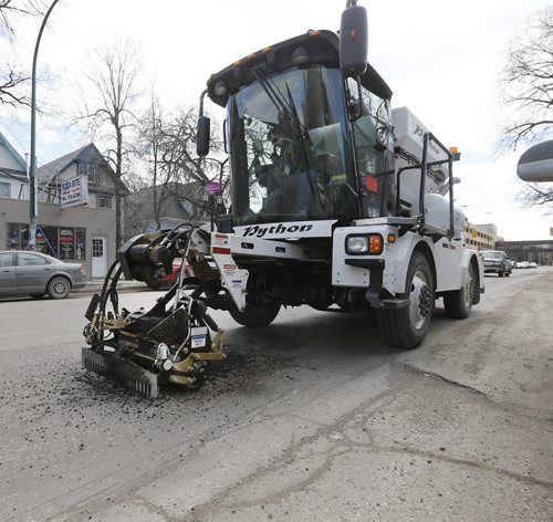 Stdup Local , Pot Hole fixing is underway along Sherbrook St. with a new  piece of equipment  used by the City of Wpg.  called the Python 5000 , it spreads cold asphalt , rakes and also has a roller the flattens the asphalt before it moves on to the next  hole .  April 10 2014 / KEN GIGLIOTTI / WINNIPEG FREE PRESS