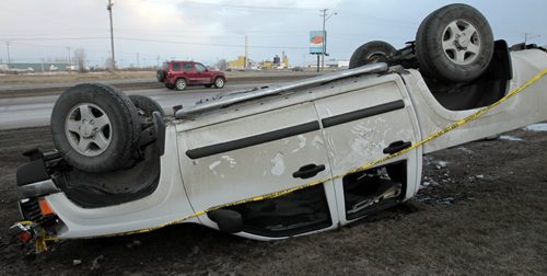 An overturned vehicle along Lagimodiere Blvd. near Dawson Rd. is ready to be towed away after a mishap Friday morning. Emergency crews were in attendance earlier. No information on injuries, below freezing temperatures have caused some icy patches. Wayne Glowacki/Winnipeg¤¤Free Press April 11 2014