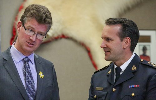 Justice Minister Andrew Swan and Assistant Commisioner Kevin Brosseau talk turkey after the announcement of the funding of ten new RCMP positions from the Manitoban government at the NCO mess hall,  RCMP "D" division in Winnipeg on Friday, April 11, 2014. The ten new positions will bring the provinces RCMP total to 798 positions. (Photo by Crystal Schick/Winnipeg Free Press/Winnipeg Free Press)