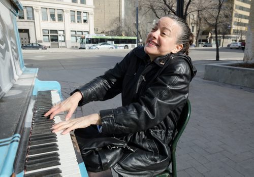 Yvette Berger plays on a public piano on William Avenue and Main Street in the early evening of Friday April 11, 2014.  Berger often plays the public pianos around the city and has her own small business performing at weddings and special occasions.  EMILY CUMMING / WINNIPEG FREE PRESS APRIL 11, 2014