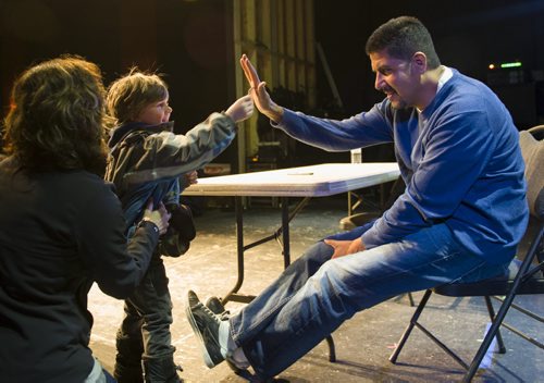 140412 Winnipeg - DAVID LIPNOWSKI / WINNIPEG FREE PRESS - April 12, 2014  Legendary Montreal QB Anthony Calvillo high fives Owen Hamilton, as his mom Sue-Anne looks on Saturday afternoon as the QB was in town for an autograph signing at The Park Theatre.